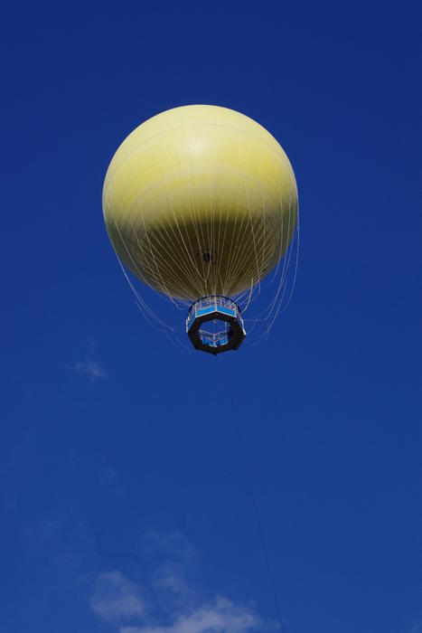 a yellow spherical tethered balloon